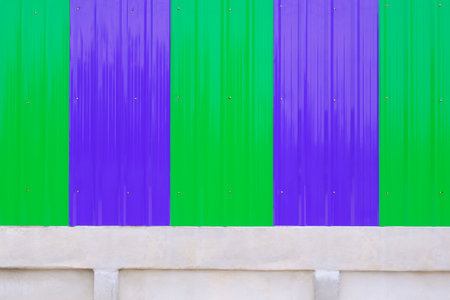 Renovate and extension of the fence wall to make it higher by installing blue and green corrugated...