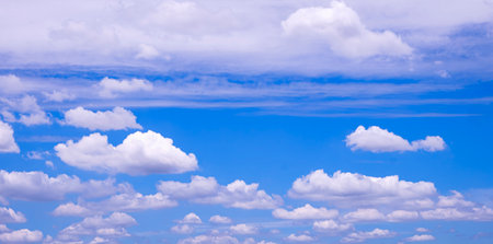 Many white fluffy clouds floating on blue sky background, beautiful summer cloudscape backdrop