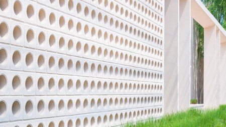 White ventilation block on fence wall decoration with grass outside of modern coffee shop, perspective side viewの写真素材
