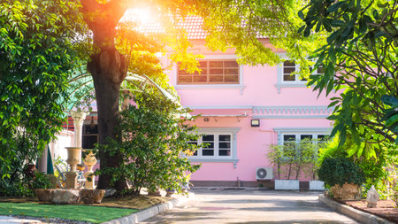 Home gardening background, modern pink house with garden in front yard areaの写真素材