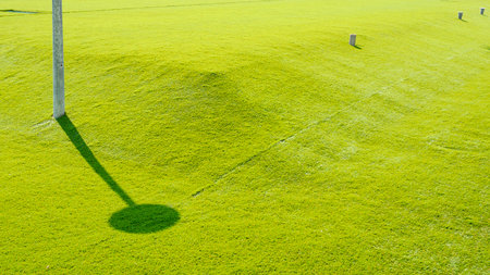 Artificial grass fields decorated on the ground in a large wastewater treatment pond areaの写真素材