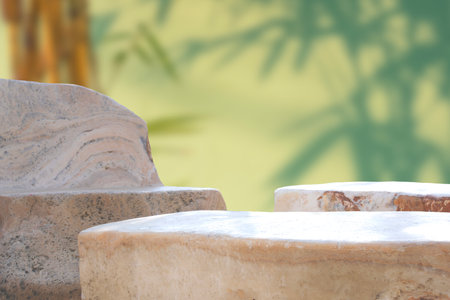 Natural beige rock stone table set on blurred greenery background in home garden areaの写真素材