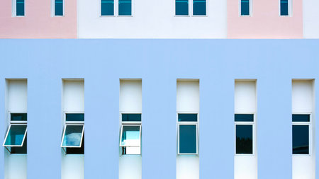 Row of awning windows on pastel concrete wall of modern office building, Geometric exterior...