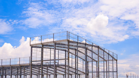 Geometric metal structure of industrial factory warehouse building framework in construction site...