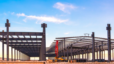 Metal structure of modern factory industrial building framework with crane truck and construction...