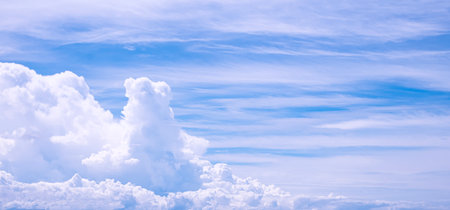 Cloudscape panoramic view with many white clouds on blue sky background