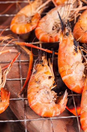 grilled prawns on flaming grillの写真素材