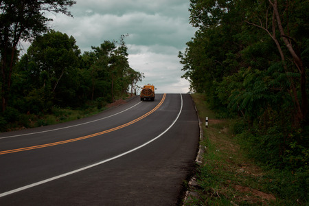File asphalt road perspective to horizon through cultivated field against cloudy skyの写真素材