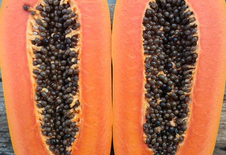 Sliced fresh papaya on wooden backgroundの写真素材