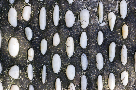 Spa stones in the concrete background. Foot massage health conceptの写真素材