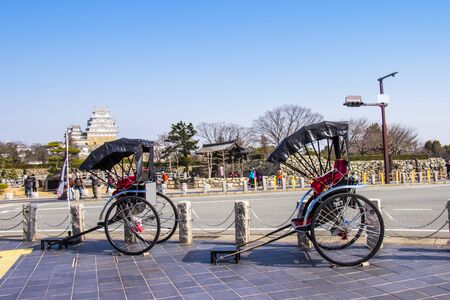 HIMEJI, JAPAN - MARCH 11, 2018: Rickshaw waiting for tourist service around himeji castle on day blue sky bright hyogo prefecture. Japanのeditorial素材