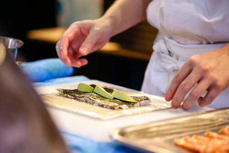 chef hands preparing japanese food, chef making sushi, Preparing Sushi rollの写真素材