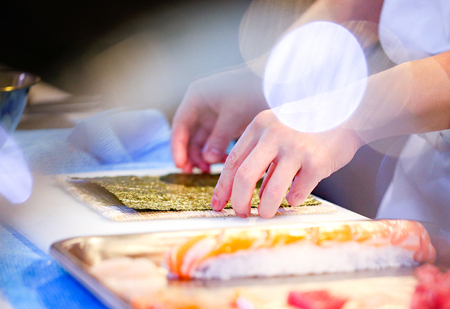 chef hands preparing japanese food, chef making sushi, Preparing Sushi rollの写真素材