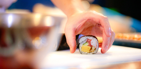chef hands preparing japanese food, chef making sushi, Preparing Sushi rollの写真素材