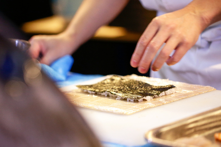 chef hands preparing japanese food, chef making sushi, Preparing Sushi rollの写真素材
