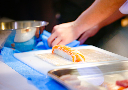 chef hands preparing japanese food, chef making sushi, Preparing Sushi rollの写真素材