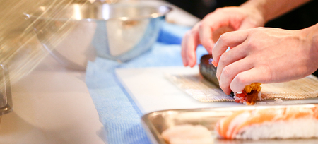 chef hands preparing japanese food, chef making sushi, Preparing Sushi rollの写真素材