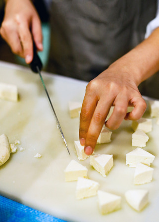 Chef slicing tofu for cooking, Chef cooking food in the kitchen, Fresh tofuの写真素材