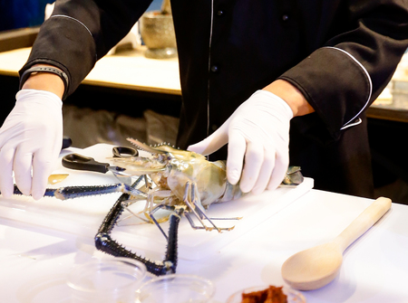 chef cooking seafood, Hand cutting raw black tiger prawnの写真素材