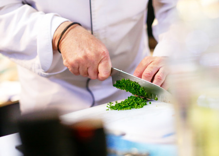 chopping green onion, Chef cutting fresh vegetables for cookingの写真素材