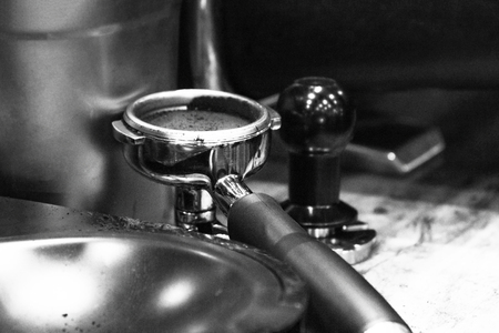 Barista working in a coffee shop, Close up of barista presses ground coffee using tamper, Barista Make Coffee Portafilter Conceptの写真素材
