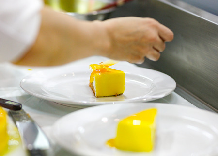chef decoration lemon cheesecake, Pouring caramel sweet sauce to deliciousの写真素材