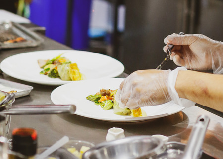Chef preparing food, meal, in the kitchen, chef cooking, Chef decorating dish, closeupの写真素材