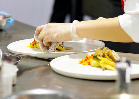 Chef preparing food, meal, in the kitchen, chef cooking, Chef decorating dish, closeupの写真素材
