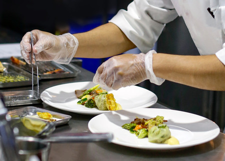 Chef preparing food, meal, in the kitchen, chef cooking, Chef decorating dish, closeupの写真素材