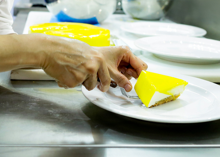chef decoration lemon cheesecake, Pouring caramel sweet sauce to deliciousの写真素材
