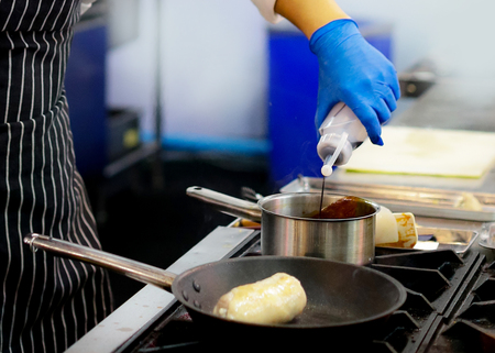 Chef preparing food, meal, in the kitchen, chef cooking, Chef decorating dish, closeupの写真素材
