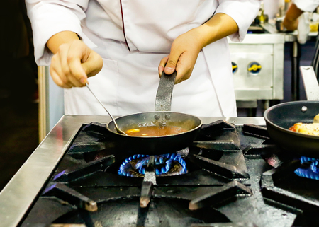 Chef preparing food, meal, in the kitchen, chef cooking, Chef decorating dish, closeupの写真素材