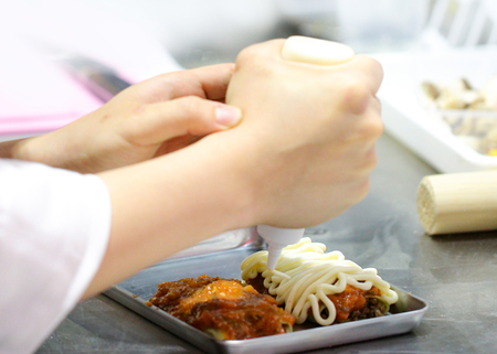 Chef preparing food, meal, in the kitchen, chef cooking, Chef decorating dish, closeupの写真素材