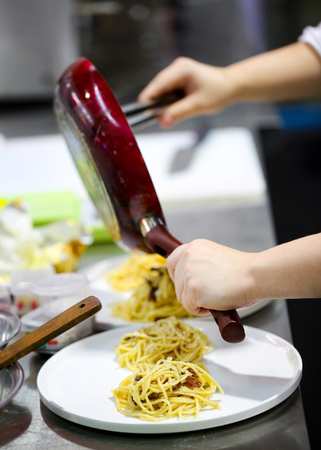 Chef cooking, Chef preparing food, meal in the kitchen, Delicious spaghettiの写真素材