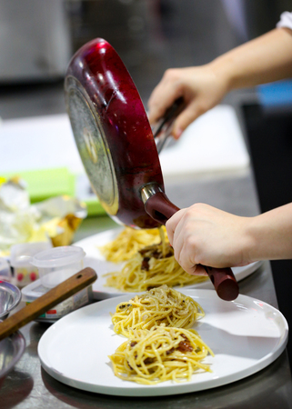 Chef cooking, Chef preparing food, meal in the kitchen, Delicious spaghettiの写真素材