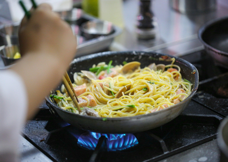 Chef cooking, Chef preparing food, meal in the kitchen, Delicious spaghettiの写真素材