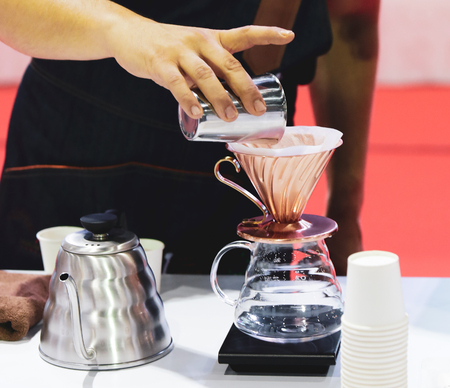 Barista is making coffee, coffee preparing with coffee dripper, Dripping hot fresh coffeeの写真素材