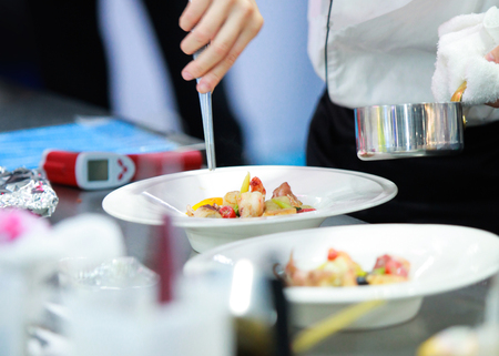 Chef preparing food, meal, in the kitchen, chef cooking, Chef decorating dish, closeupの写真素材