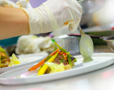 Chef preparing food, meal, in the kitchen, chef cooking, Chef decorating dish, closeupの写真素材