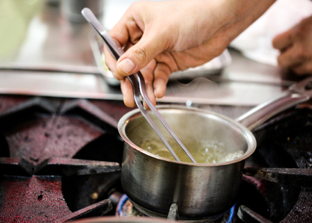 Chef preparing food, meal, in the kitchen, chef cooking, Chef decorating dish, closeupの写真素材