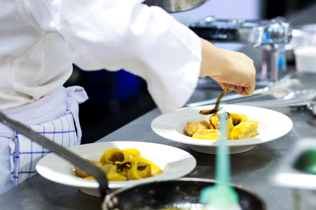 Chef preparing food, meal, in the kitchen, chef cooking, Chef decorating dish, closeupの写真素材