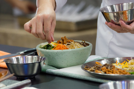Bibimbap, Traditional Korean cuisine bibimbap, Chef preparing Korean food, chef cooking in kitchenの写真素材