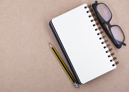 Book and pencils from top view, background on paper of office desk conceptの写真素材
