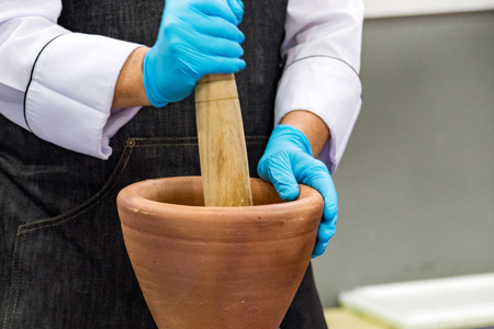 Using a mortar and pestle to pound ingredients for thai food, Pound mortarの写真素材