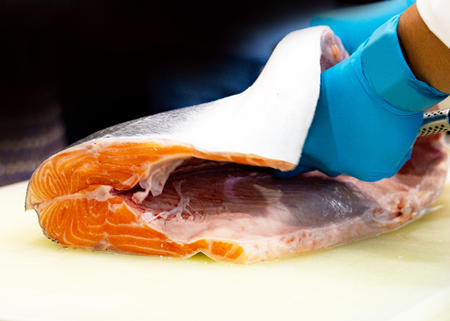 chef slicing raw fresh salmon, Chef preparing a fresh salmon on a cutting boardの写真素材