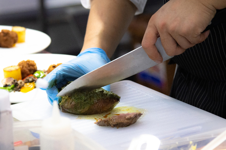 Chef preparing food, meal, in the kitchen, chef cooking, Chef decorating dish, closeupの写真素材