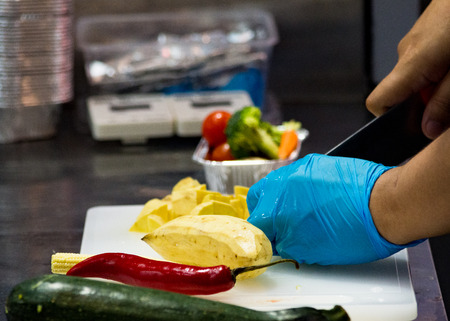 Chef cooking food, vegetables in the kitchenの写真素材