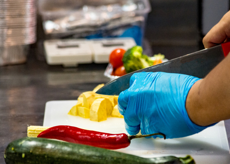 Chef cooking food, vegetables in the kitchenの写真素材