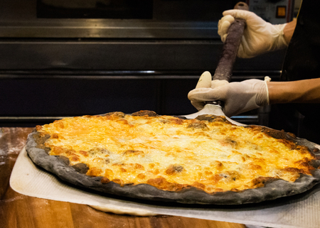 chef prepares delicious pizzas on the kitchen, view from the inside of the ovenの写真素材