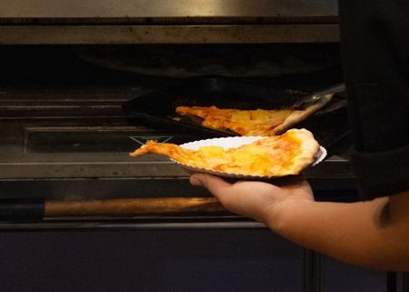 chef prepares delicious pizzas on the kitchen, view from the inside of the ovenの写真素材